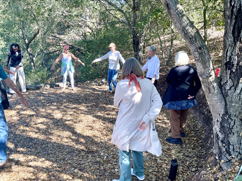 Martha leading a Qigong class outside of her studio